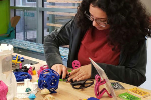 Sabrina testing a 3D print in the IgnitED lab.