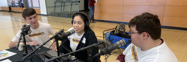 3 podcasters with headphones on