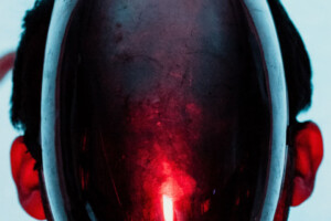 A humanoid form with a glowing red glass face