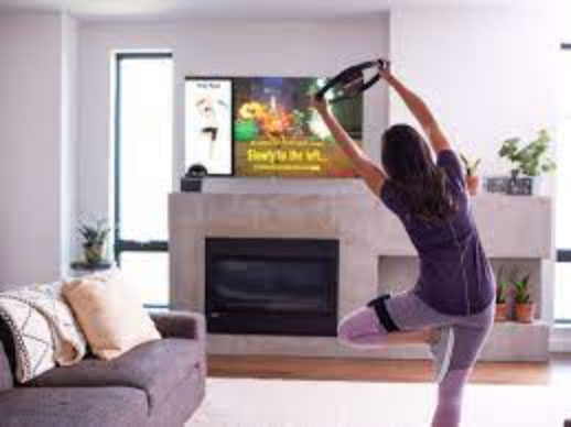 A woman working out with a Nintendo RingFit